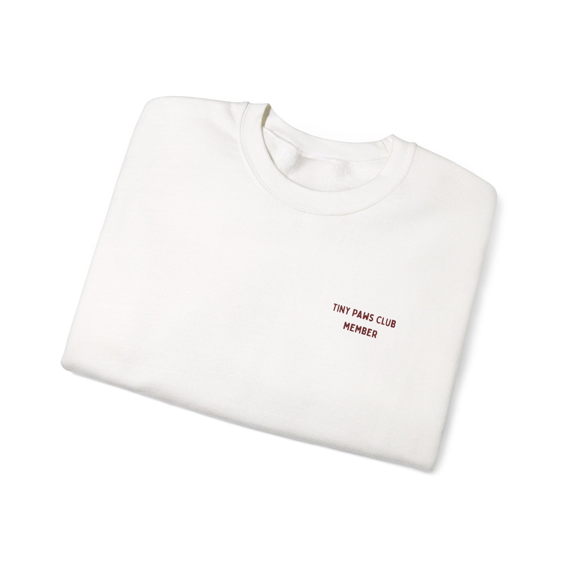 White sweatshirt with 'TINY PAWS CLUB MEMBER' text on a white background
